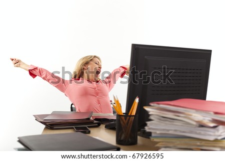 Young businesswoman stretching at desk