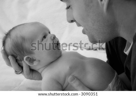 Black & White Image of a father looking down at his son