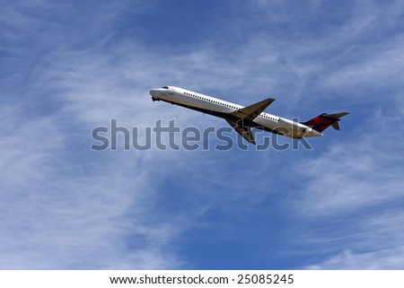 Close up of an airplane taking off against blue sky with some clouds