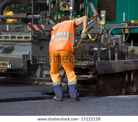 Road workers at the asphalt repairing works