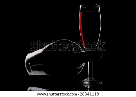 Wine glass and bottle isolated on black background