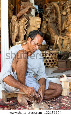 A man is making wooden crafts  in Indonesia
