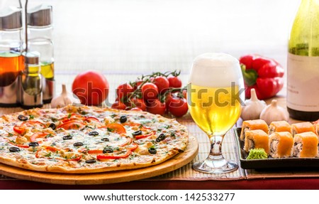 composition of beer sushi  and pizza in backlit