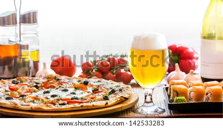 composition of beer sushi  and pizza in backlit