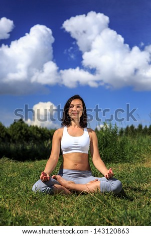 girl doing yoga outdoor looking in camera and smiling, vertical