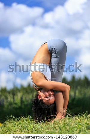 girl doing yoga outdoor looking in camera, close-up, vertical