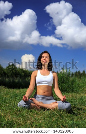 girl doing yoga outdoor with closed eyes and smiling, vertical