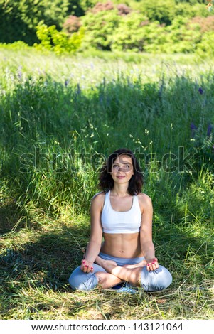 girl doing yoga outdoor with open eyes, vertical