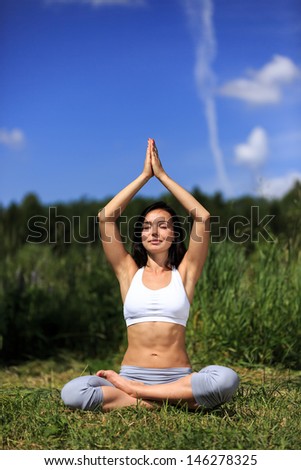 girl doing yoga outdoor with closed eyes, vertical