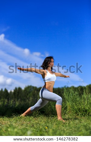 girl doing yoga outdoor with open eyes, vertical