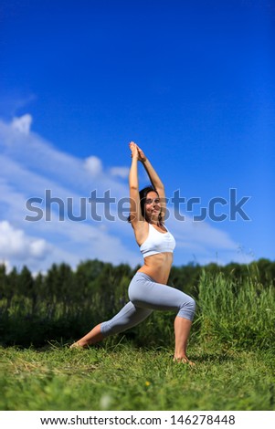 girl doing yoga outdoor looking in camera, vertical