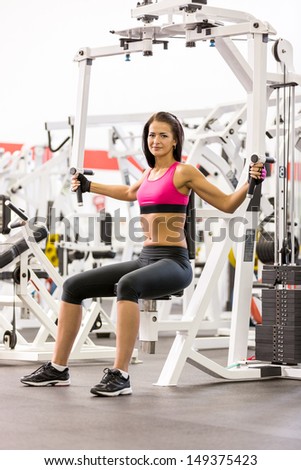 young women do a workout at the gym looking in camera