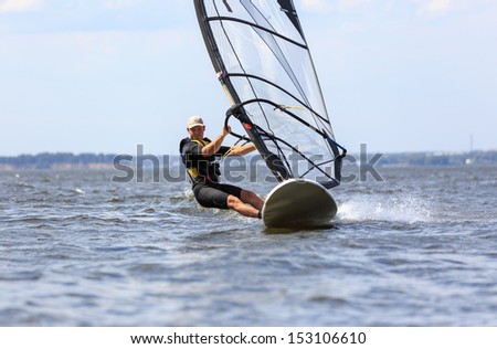 Front view of a windsurfer passing by