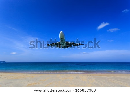 airplane landing in bright Blue sky, right before touch-down