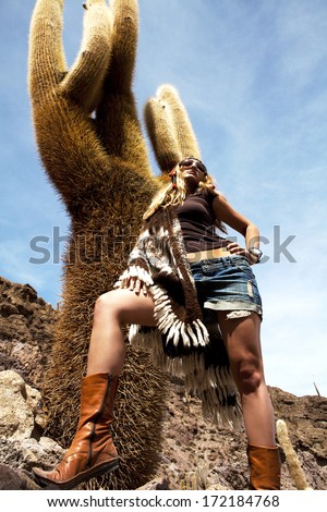 beautiful girl in national clothes standing among cacti in Salar de Uyuni, Bolivia