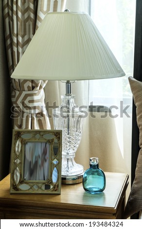 Bedside table with lamp, and picture frame
