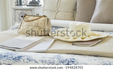 Decorative set with vintage bag,hat,books on the bed