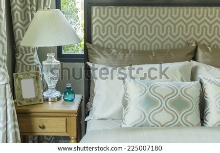 Concept for luxury bedroom with pillows and desk lamp