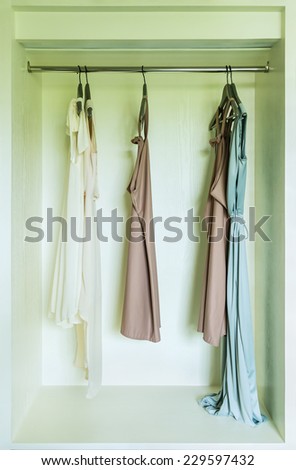 row of dress hanging on coat hanger in wardrobe