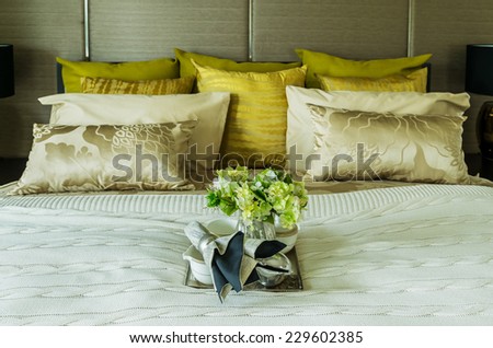 Decorative set with book,tea set and glasses on the bed