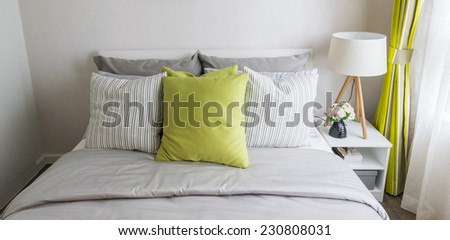 modern bedroom with green pillow on bed