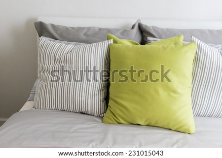 modern bedroom with green pillow on bed