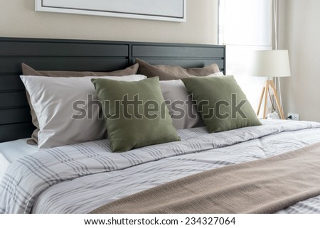 modern bedroom with green pillows on bed