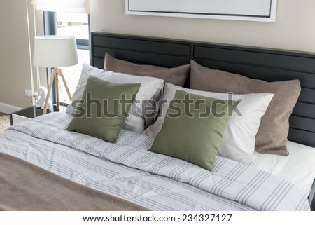 modern bedroom with green pillows on bed