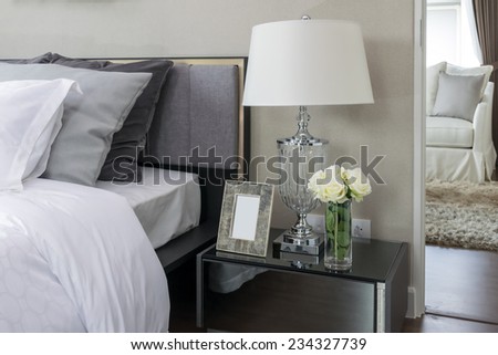bed and pillows with white lamp on table