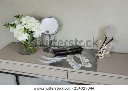 Beauty and make-up concept: mirror,jewelry and makeup set on a table