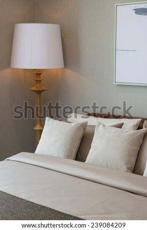 modern bedroom with wooden lamp and pillows