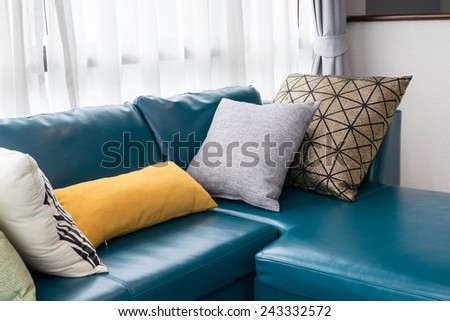 modern living room with green sofa and pillows at home