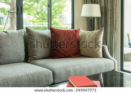 modern living room design with red pillows on sofa and lamp