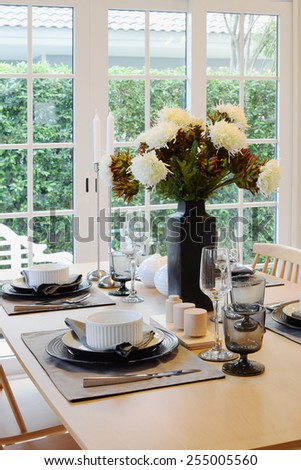 wooden table in dining room with elegant table setting
