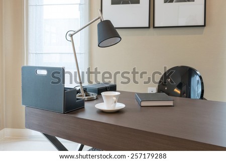 wooden table and books in modern working room interior