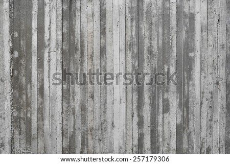 texture of wooden form work stamped on a raw concrete wall as background
