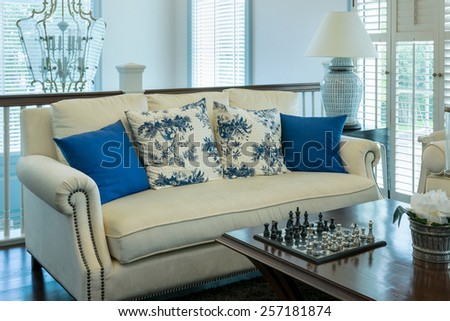 luxury living room with blue pattern pillows on sofa and decorative chess board