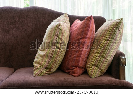 red pillows on red sofa in luxury living room interior