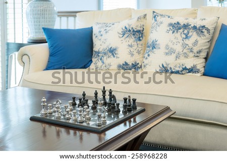 decorative chess board with chess pieces in luxury living room interior