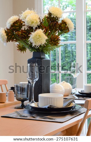 wooden table in dining room with elegant table setting