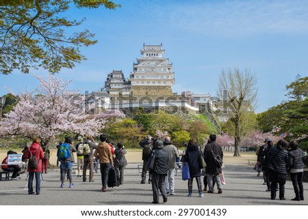 Himeji, Japan - Apr 09, 2015: Himeji Castle with tourist and cherry blossom in spring. Himiji castle is landmark and one of the main tourist attraction in Japan.