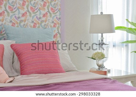 Colorful romantic bedding style with beautiful pattern headboard and crystal base reading lamp