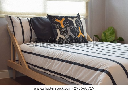 Modern bedroom interior with pillows on wooden bed base