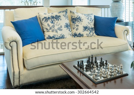 luxury living room with blue pattern pillows on sofa and decorative chess board