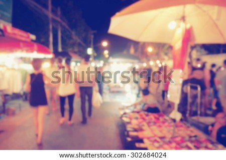 vintage photo effect of blurred people walking at night market walking street, Chiang Mai, Thailand