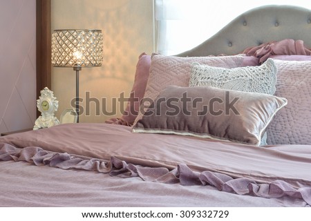 Cozy  and classic  bedroom interior with pillows and reading lamp on bedside table
