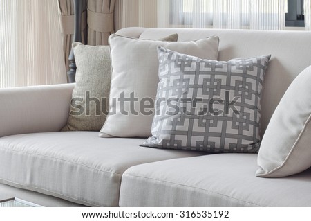 Earth tone sofa set with varies pattern pillows in living room