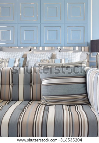 Light blue and light brown striped sofa set with classic blue wall