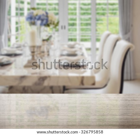 granite table top and blur of dining table and comfortable chairs in vintage style with elegant table setting