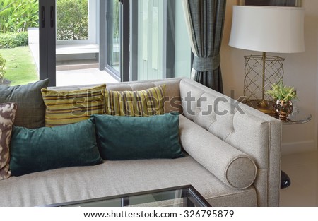luxury living room design with classic sofa, armchair and decorative table lamp